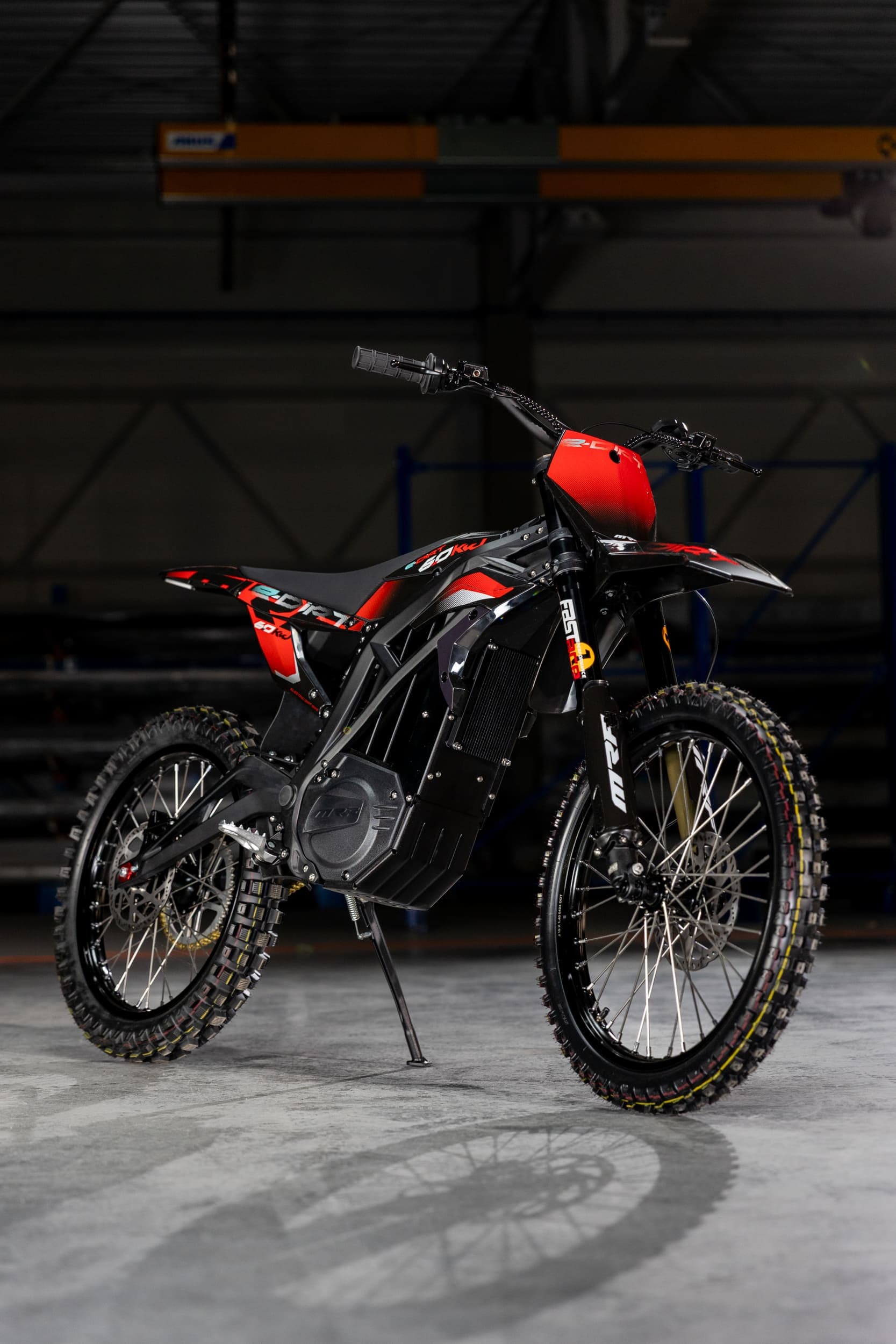 Rider on dirt bike performing maintenance